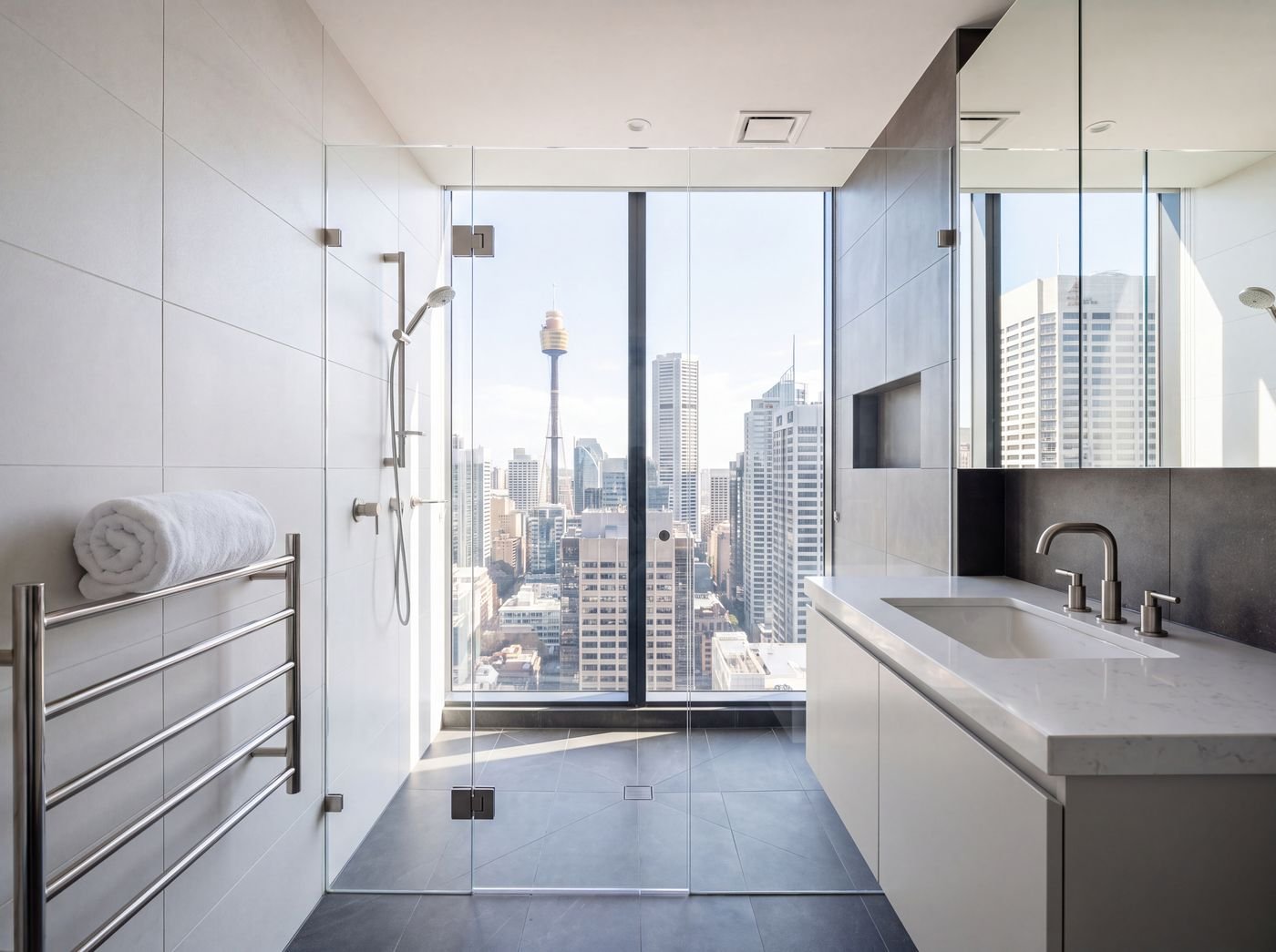 Freshly cleaned ensuite bathroom with glass shower and freestanding tub